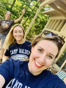 Three camp counselors smile for the camera as one waves. These are the counselors at Camp Walden & Camp Therapyology. Contact us to learn about summer programs for teens in West Bloomfield, MI. Summer camp can help your teen grow!