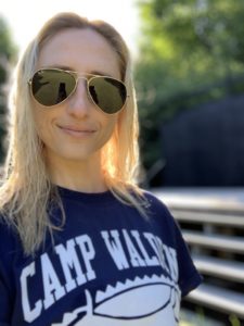 Brooke B smiles with sunglasses and a Camp Walden shirt. She offers support through Camp Therapyology. Learn more about summer camps in West Bloomfield, MI. Summer programs for teens can help your teen grow!